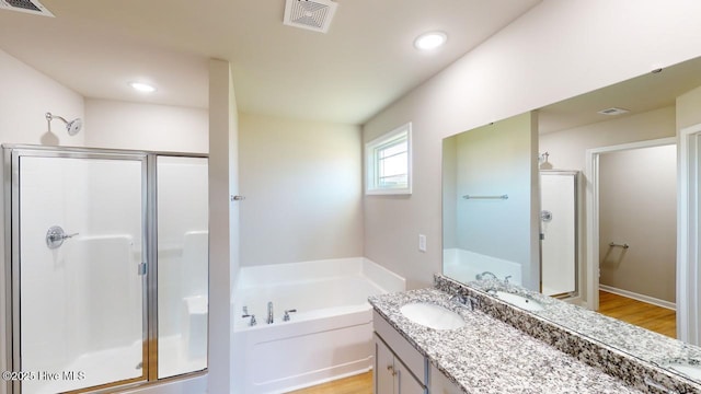 bathroom featuring a bath, visible vents, and a stall shower