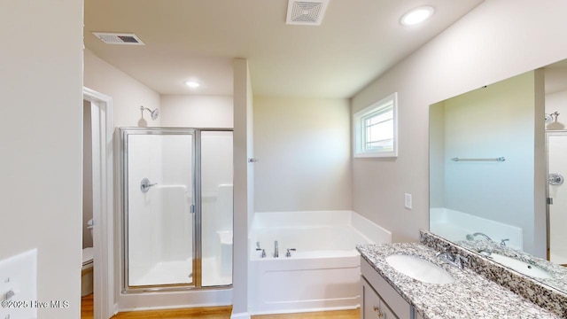 full bath featuring visible vents, a shower stall, and a garden tub