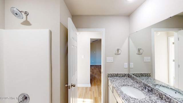 bathroom with vanity and wood finished floors