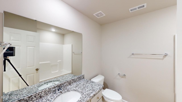 bathroom with visible vents, toilet, and vanity