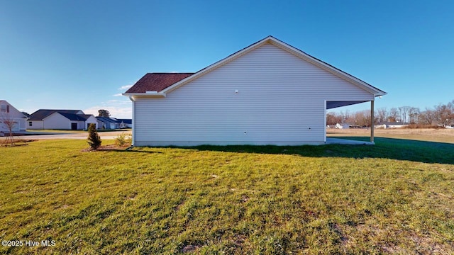 view of side of property with a yard