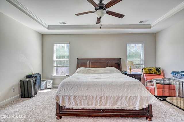 carpeted bedroom with a tray ceiling, visible vents, and multiple windows