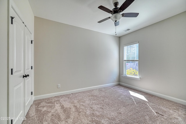 unfurnished bedroom featuring carpet flooring, visible vents, baseboards, and a closet