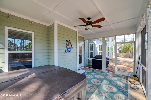 sunroom / solarium featuring ceiling fan