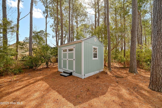 view of shed featuring fence