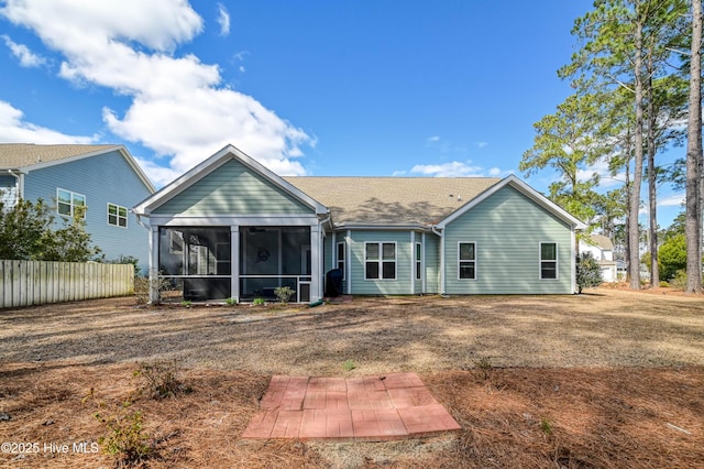 back of property featuring fence and a sunroom