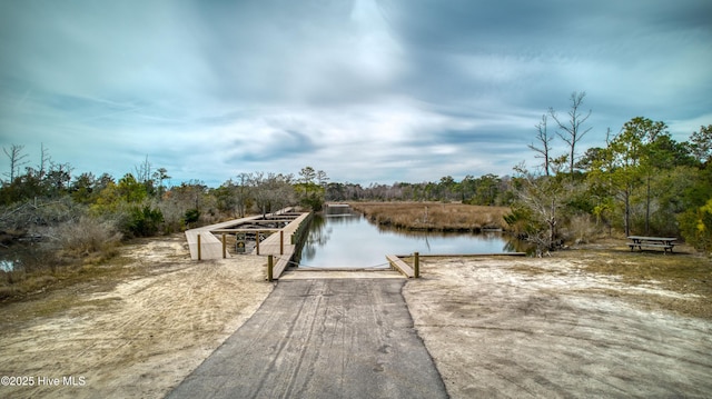 view of dock with a view of trees and a water view