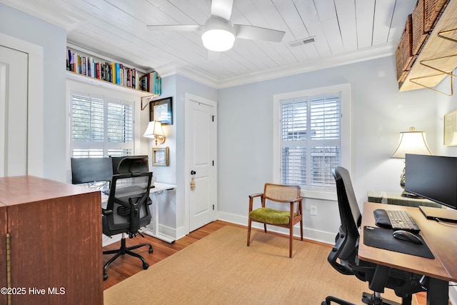 office space with visible vents, baseboards, ornamental molding, wood finished floors, and a ceiling fan