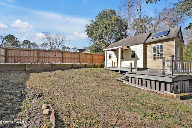 view of yard with a deck and fence