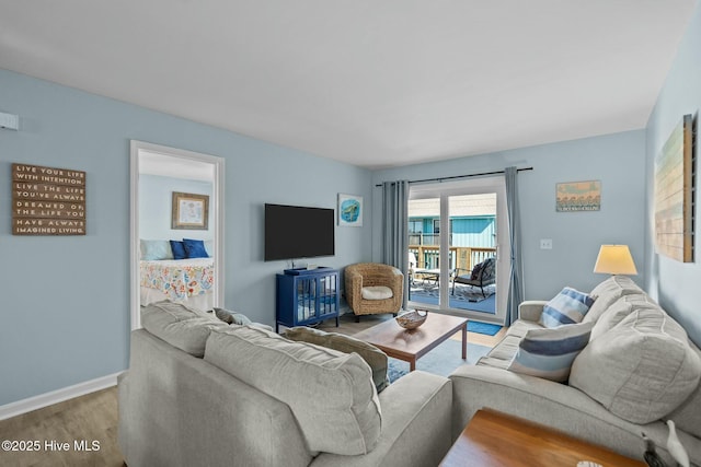 living room with baseboards and wood finished floors