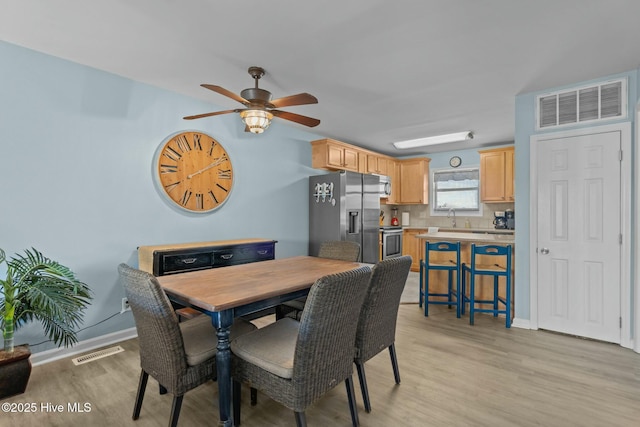 dining area with visible vents, baseboards, and light wood-style floors