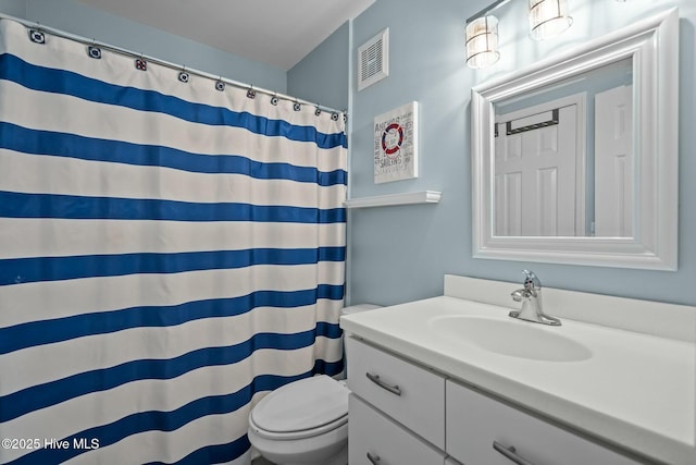 bathroom featuring visible vents, curtained shower, toilet, and vanity