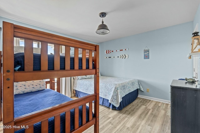 bedroom with wood finished floors and baseboards