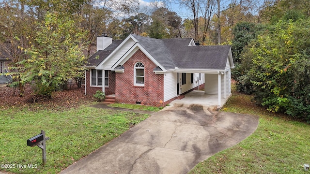 view of front facade featuring brick siding, a carport, a front yard, a chimney, and crawl space