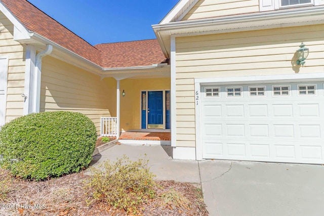 entrance to property with a porch and a garage