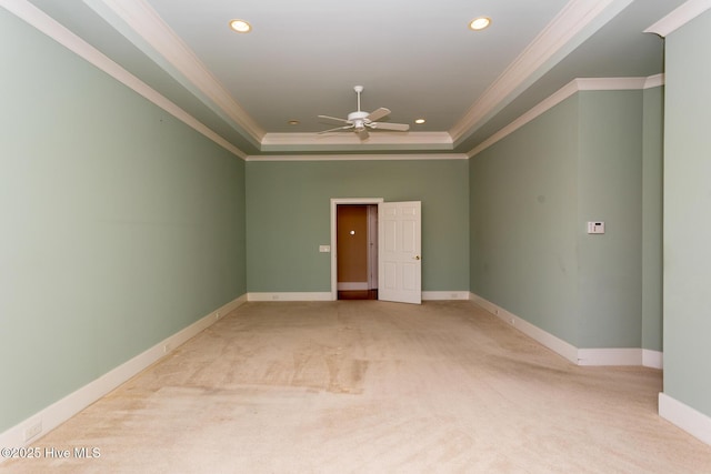 carpeted spare room with recessed lighting, baseboards, a raised ceiling, and ornamental molding