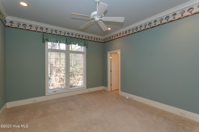 empty room with a ceiling fan, recessed lighting, carpet flooring, crown molding, and baseboards