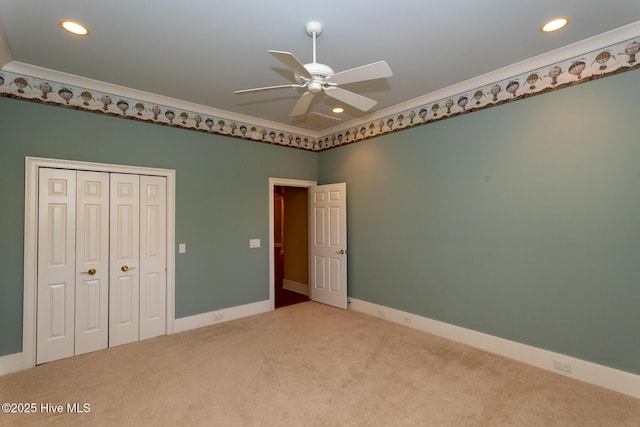 unfurnished bedroom with a closet, recessed lighting, baseboards, and carpet