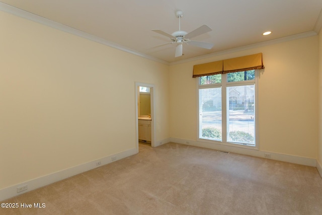 unfurnished room featuring baseboards, light carpet, ornamental molding, and a ceiling fan