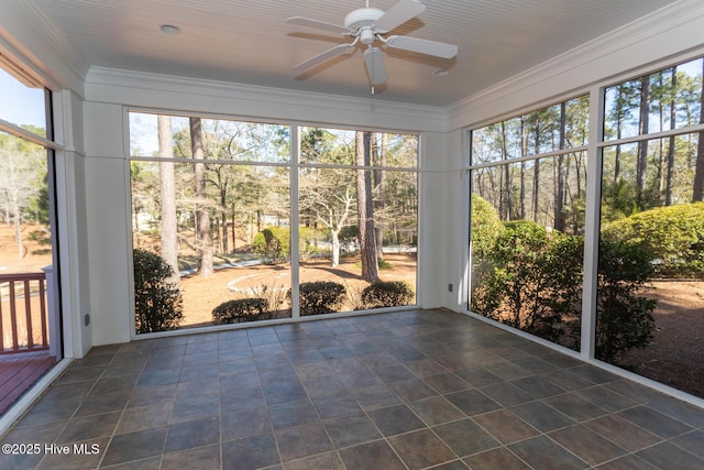 unfurnished sunroom featuring ceiling fan