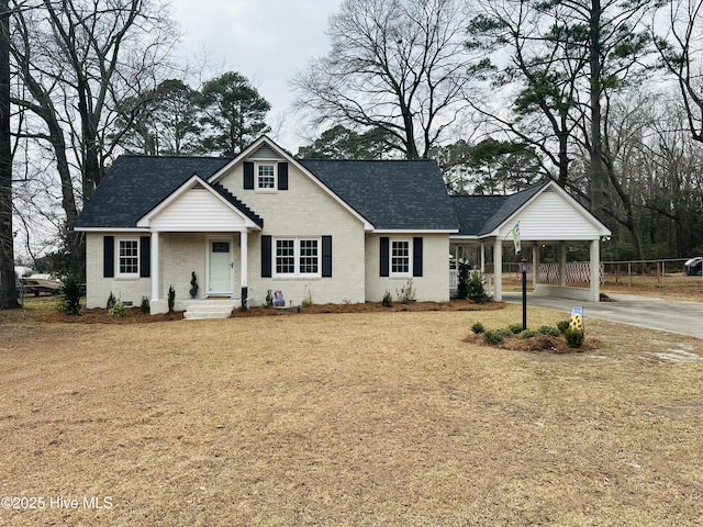 view of front of home with fence, a carport, brick siding, and a shingled roof