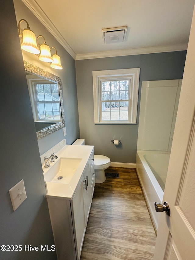 full bathroom featuring visible vents, toilet, wood finished floors, crown molding, and vanity