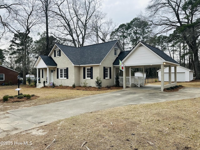 view of front of house with an outbuilding and a shingled roof