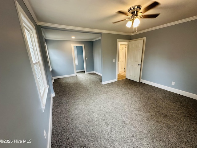 unfurnished room featuring dark carpet, ceiling fan, baseboards, and ornamental molding