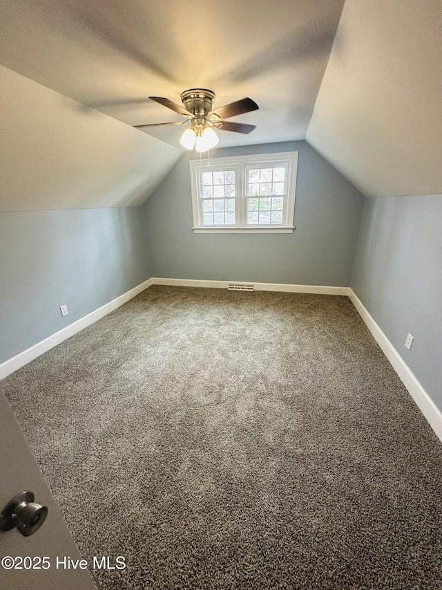 bonus room featuring a ceiling fan, baseboards, visible vents, carpet floors, and lofted ceiling