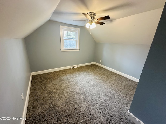 bonus room with carpet flooring, baseboards, and vaulted ceiling