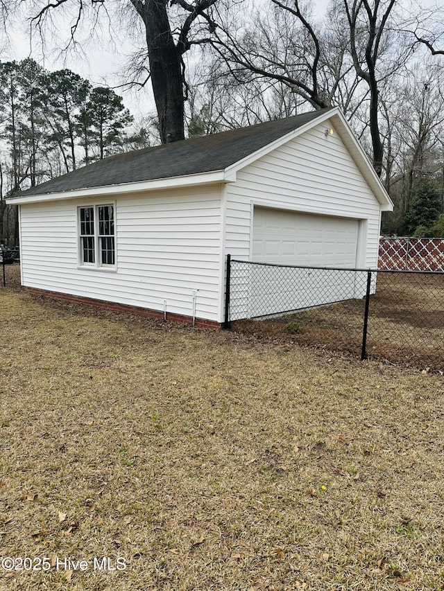 detached garage featuring fence