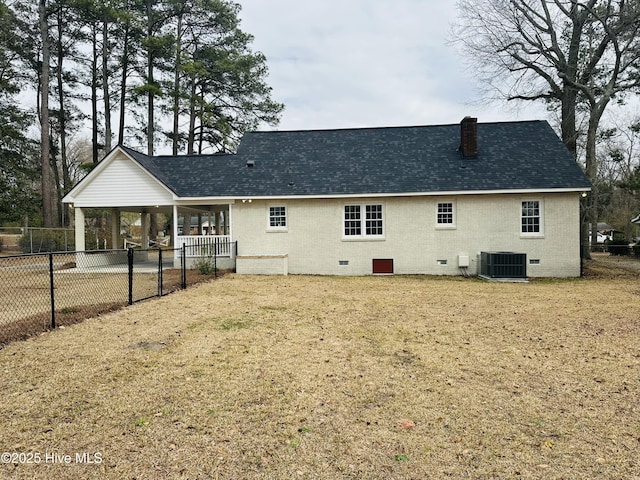 back of property with brick siding, fence, central AC, a chimney, and crawl space