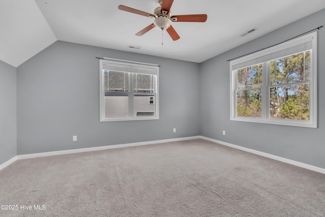 unfurnished room featuring vaulted ceiling, carpet flooring, baseboards, and visible vents