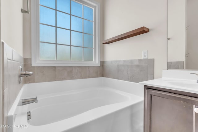 full bathroom with vanity and a bath