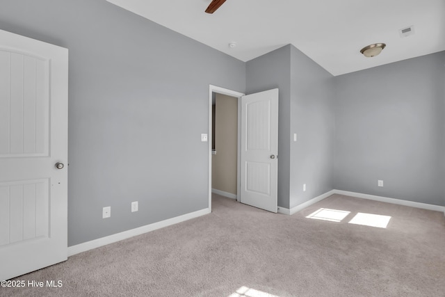 unfurnished bedroom featuring a ceiling fan, carpet, and baseboards