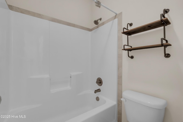 bathroom with toilet and  shower combination