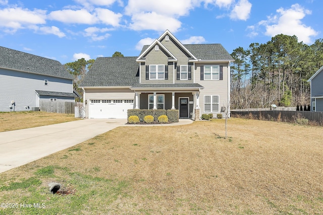 view of front of property featuring an attached garage, concrete driveway, a front yard, and fence