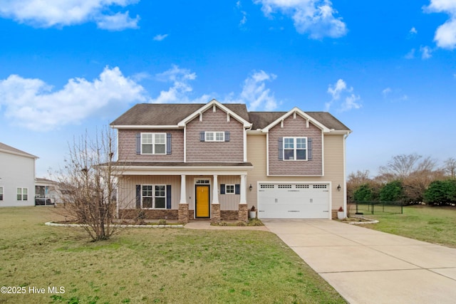 craftsman-style home with an attached garage, concrete driveway, and a front lawn