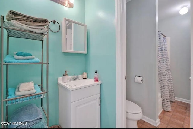 full bathroom with tile patterned floors, toilet, vanity, and baseboards