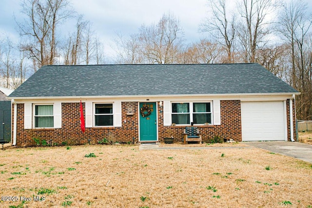 ranch-style home with driveway, brick siding, and roof with shingles