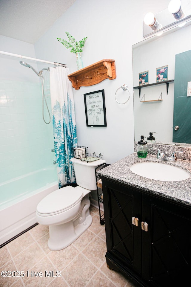 bathroom featuring tile patterned floors, vanity, toilet, and shower / bath combo with shower curtain