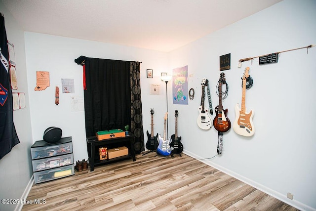 interior space featuring baseboards and wood finished floors