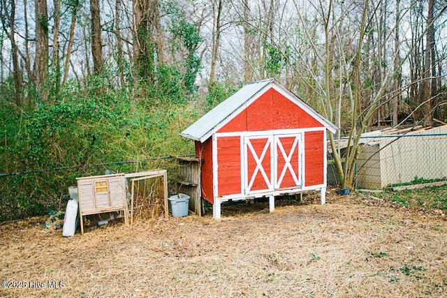 view of poultry coop featuring fence