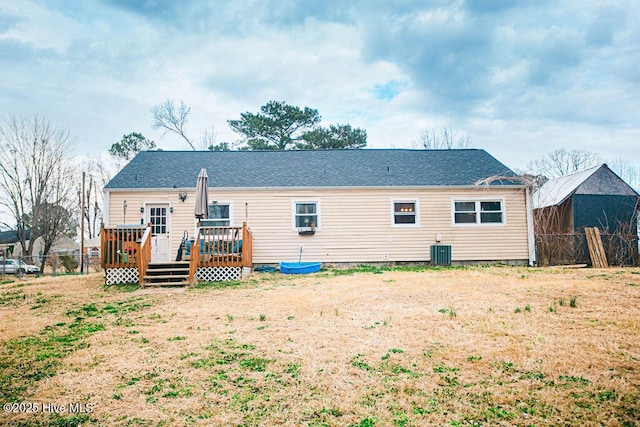 back of property with central AC unit, fence, and a wooden deck