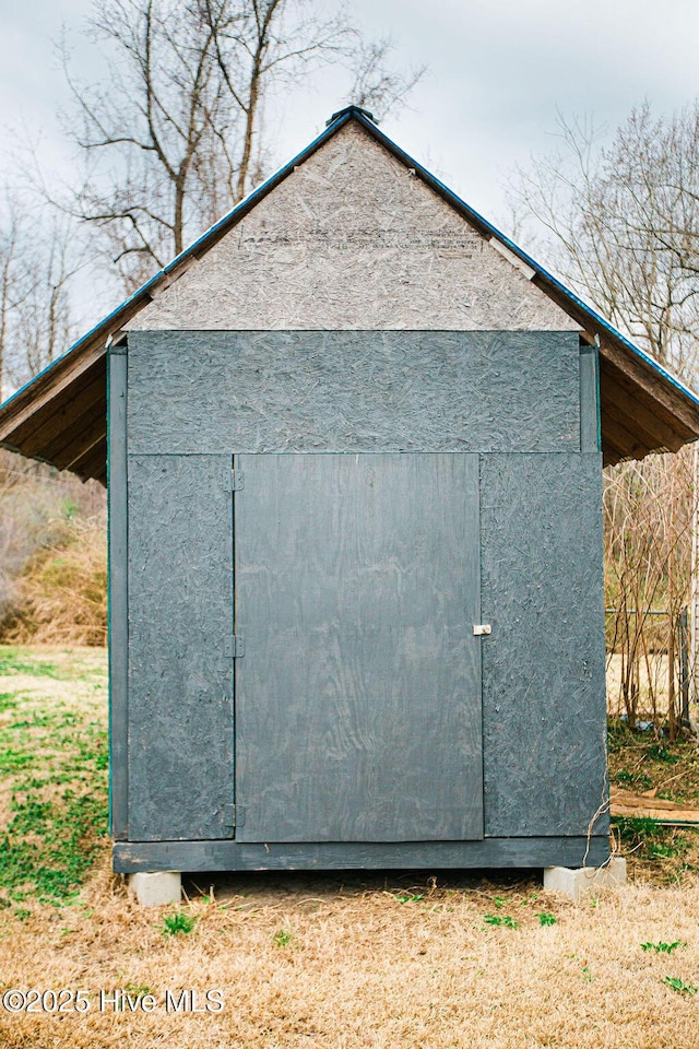 view of home's exterior featuring an outbuilding, a shed, and stucco siding