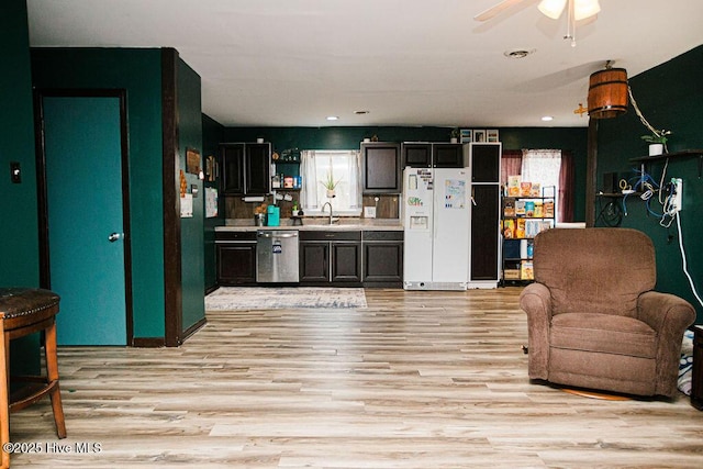 living room with recessed lighting, light wood-type flooring, and a ceiling fan