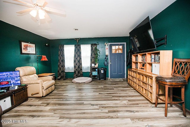 sitting room with wood finished floors and a ceiling fan