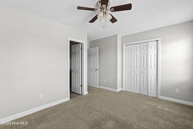 unfurnished bedroom with a closet, carpet flooring, and baseboards