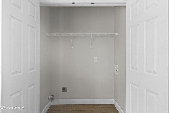 clothes washing area with baseboards, hookup for an electric dryer, dark wood finished floors, and laundry area