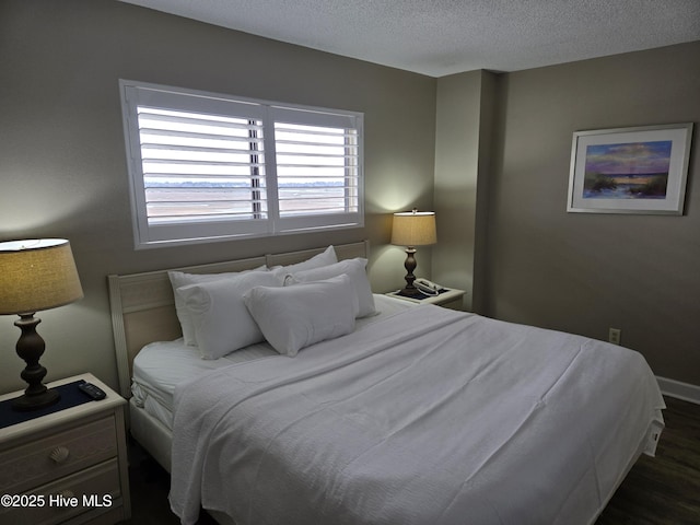 bedroom featuring wood finished floors and a textured ceiling